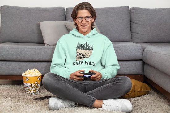 Person sitting on the floor with a gaming console, popcorn, and a &
