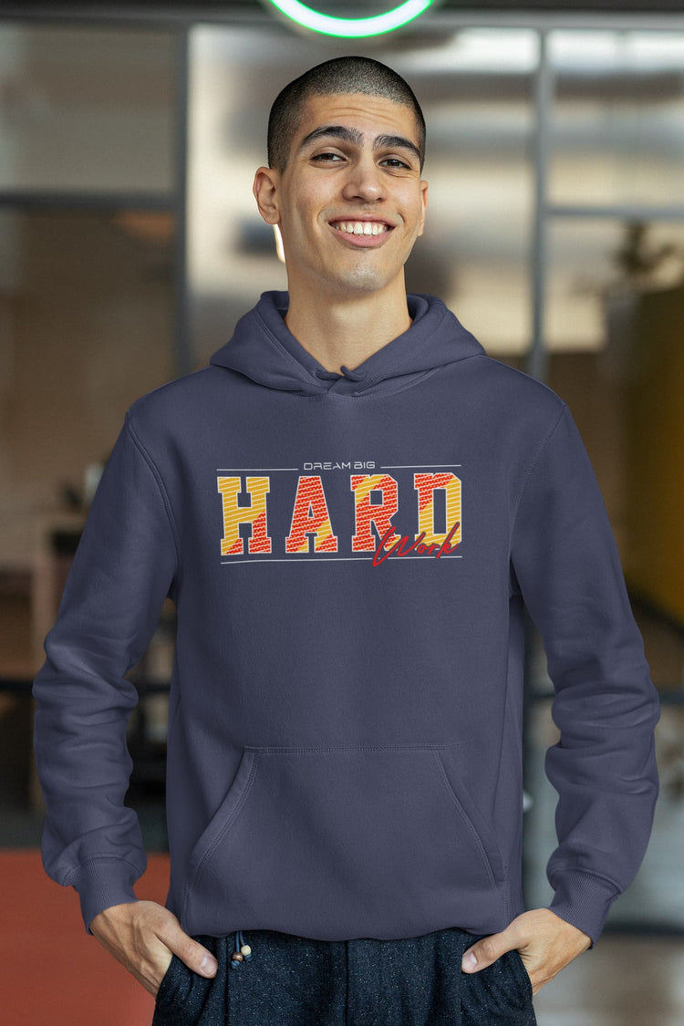 Man wearing a navy hoodie with colorful text in an indoor setting