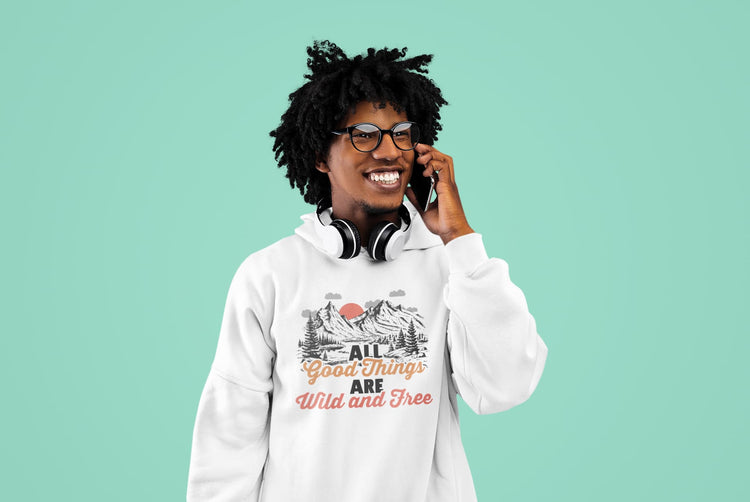 Person wearing a white hoodie with a graphic design and text on a teal background