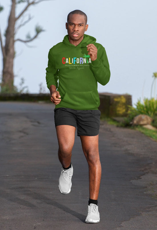 Man running outdoors wearing a green hoodie with &