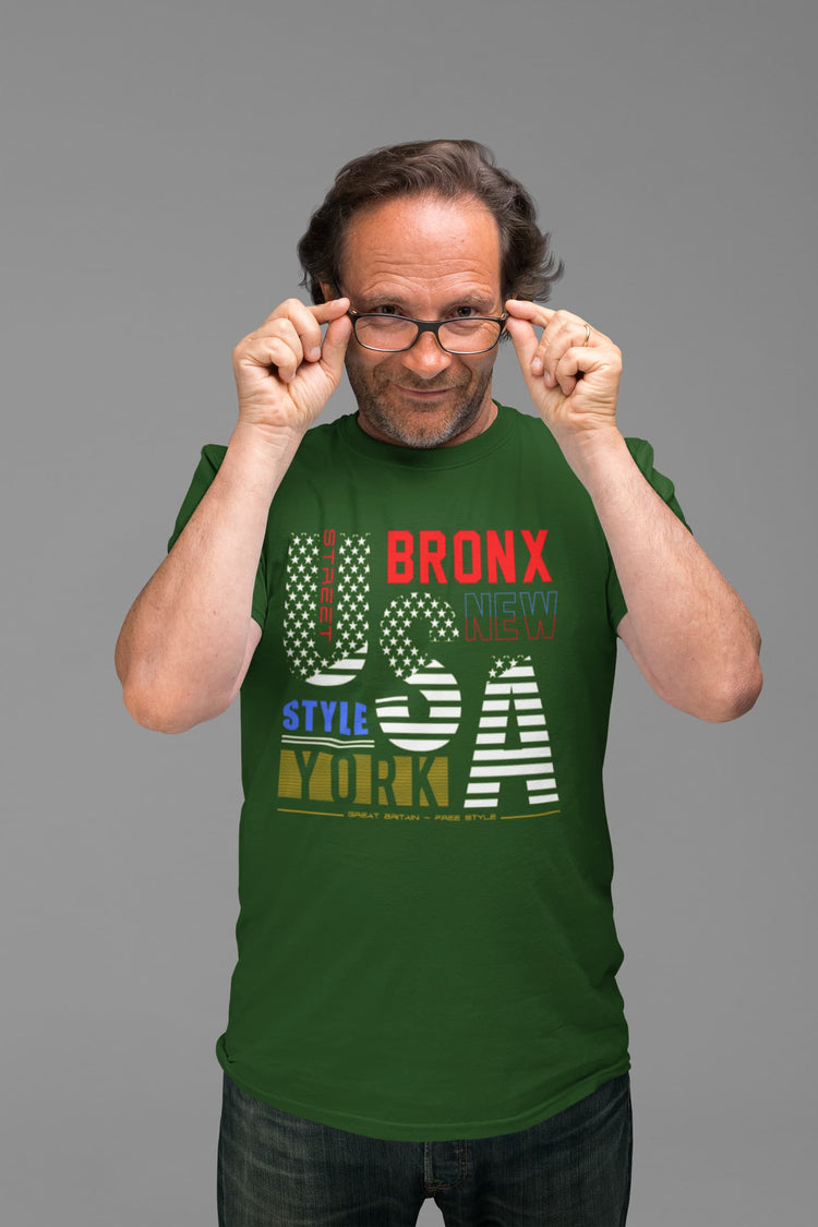 Man wearing a green t-shirt with text on a gray background