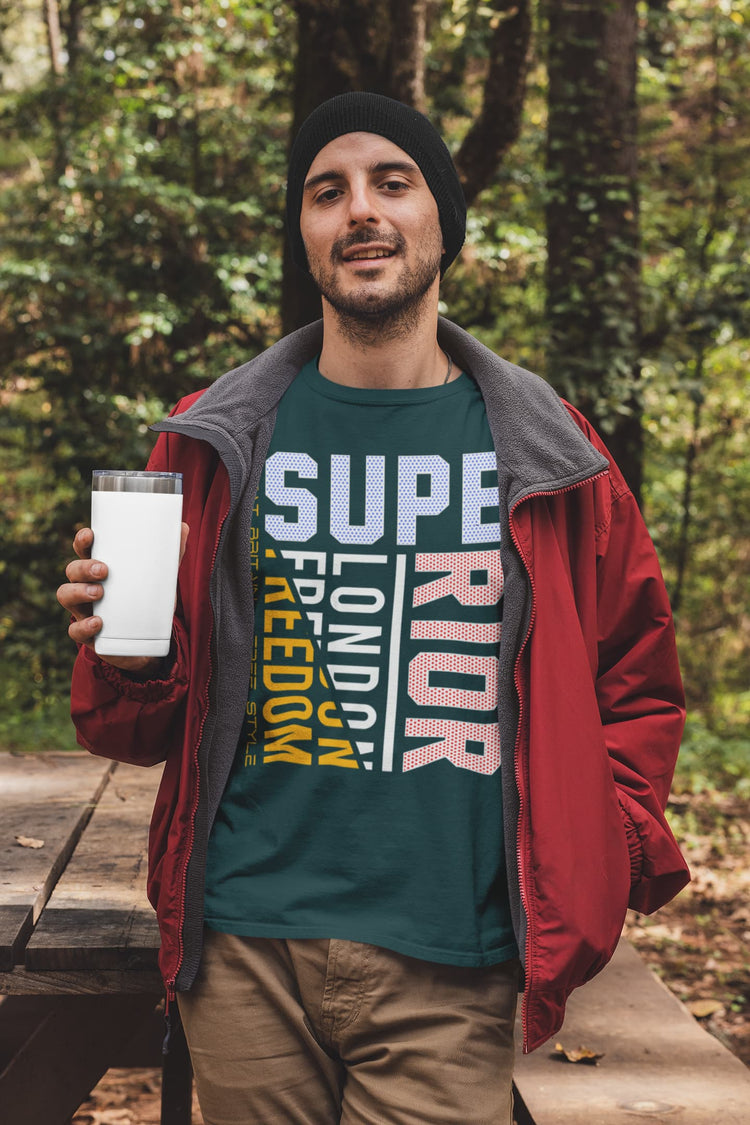 Man holding a tumbler outdoors with a forest background