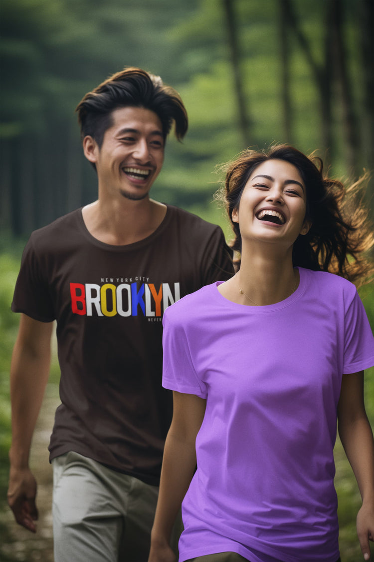 Two people walking together in a forest, one wearing a &