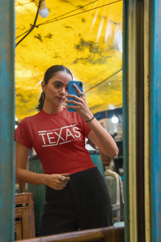 Woman taking a mirror selfie wearing a red &