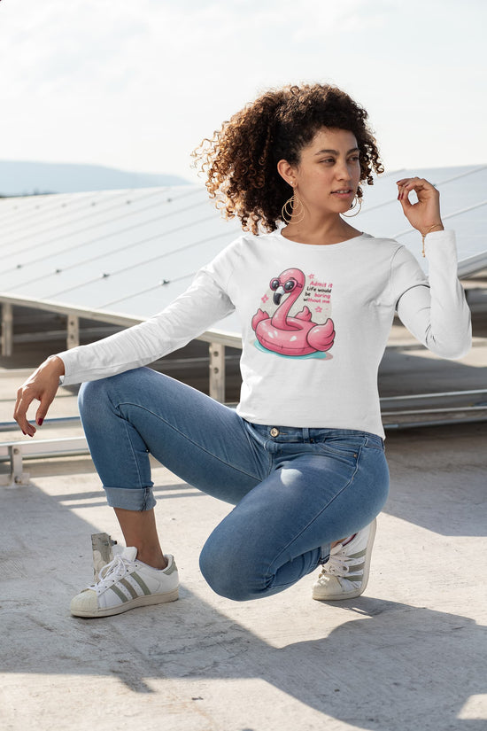 Woman wearing a white sweatshirt with a flamingo graphic and text, sitting on a rooftop.
