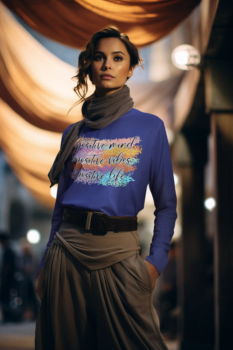 Woman wearing a blue shirt with motivational text in an indoor setting