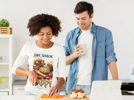 Two people in a kitchen, one cutting vegetables and the other holding a mug.