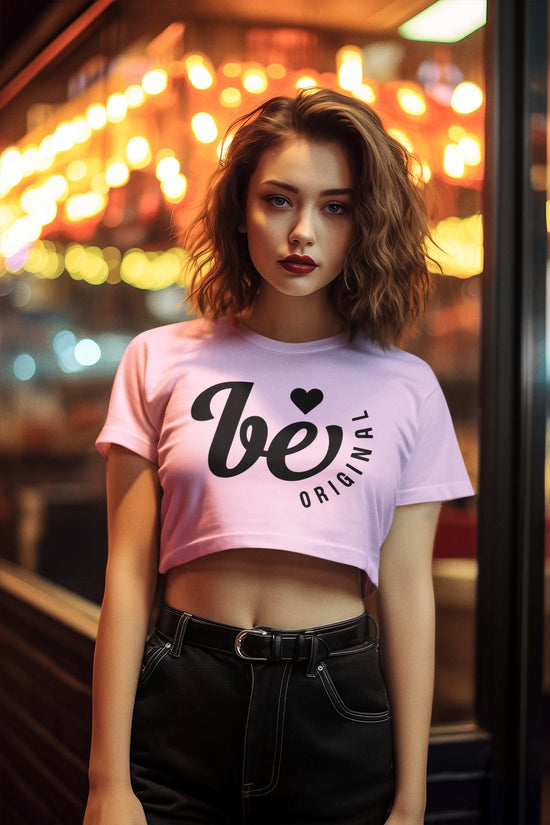 Woman wearing a pink t-shirt with text in an urban setting