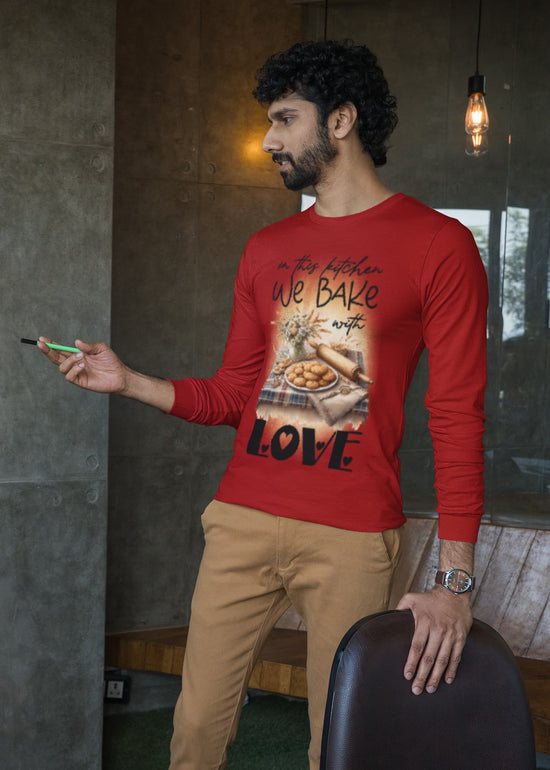 Man wearing a red long-sleeve shirt with a graphic design, standing indoors.