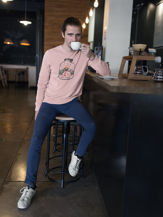 Man sitting at a bar counter in a cafe, drinking coffee