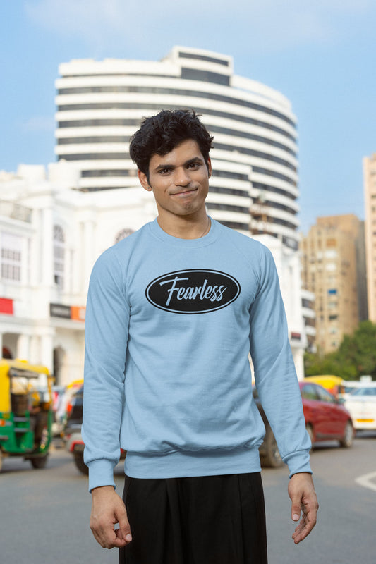 Person wearing a light blue sweatshirt with 'Fearless' text in an urban setting