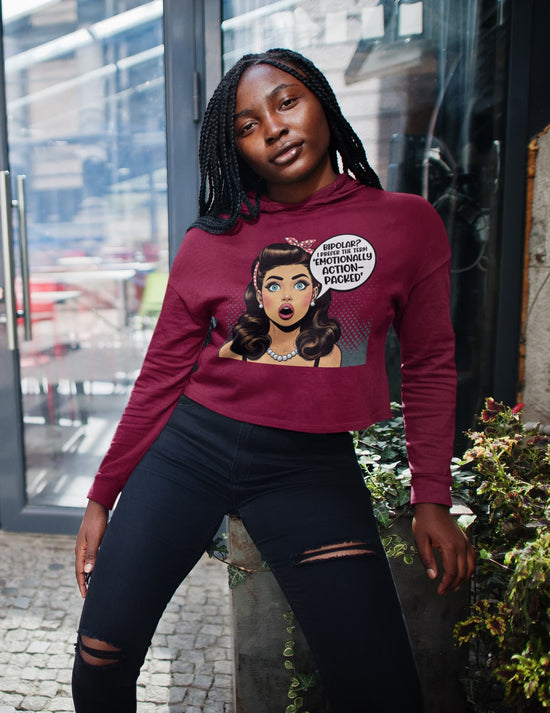 Person wearing a maroon hoodie with graphic design outdoors