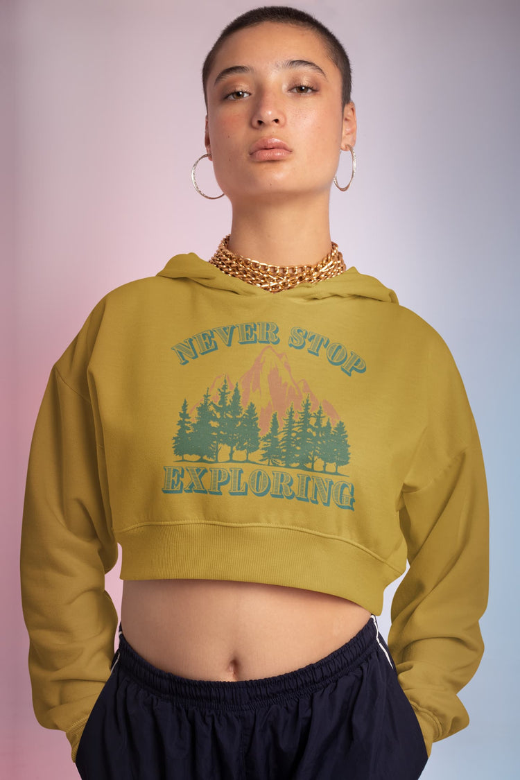 Person wearing a mustard yellow hoodie with &