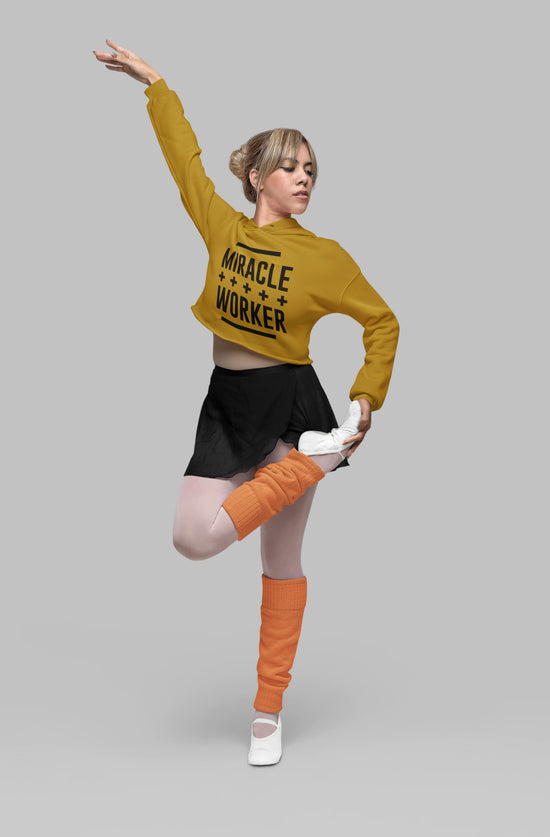 Person wearing a mustard yellow sweatshirt with &