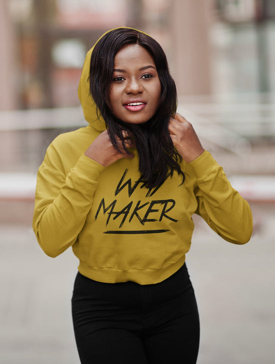 Woman wearing a yellow hoodie with &