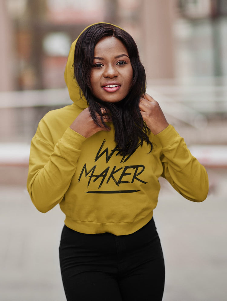 Woman wearing a yellow hoodie with &