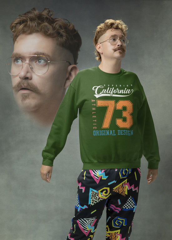 Person wearing a green sweatshirt with text and colorful pants on a gray background