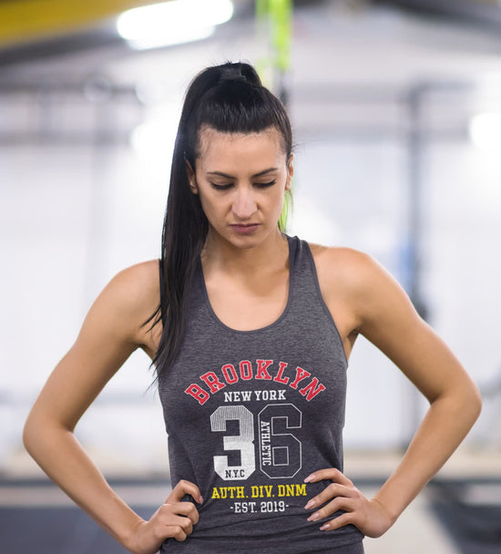 Woman wearing a gray tank top with &