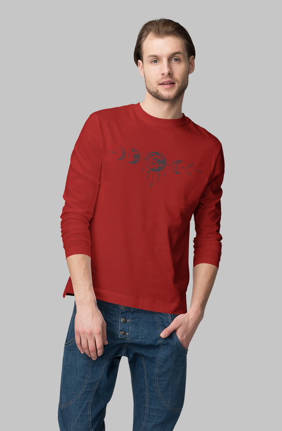 Man wearing a red sweater with a graphic design on a gray background