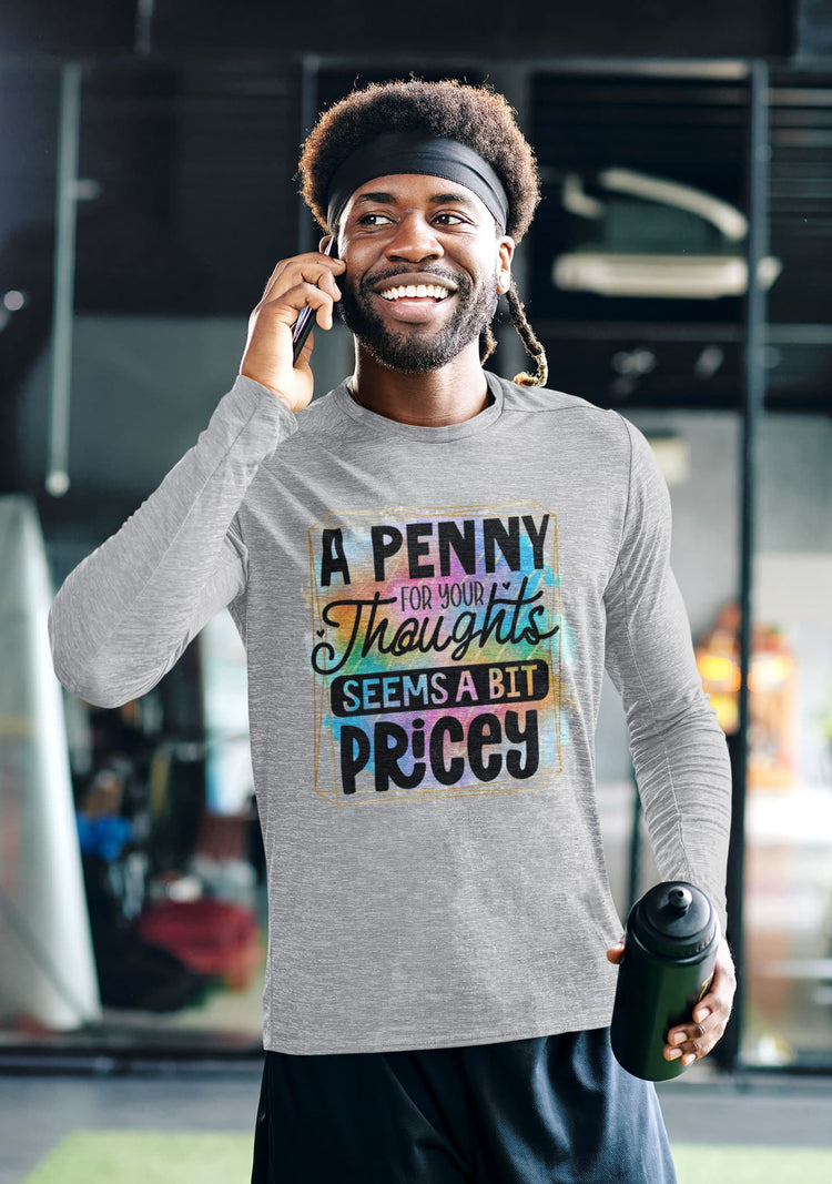 Man wearing a gray long-sleeve shirt with colorful text design, talking on a phone indoors.