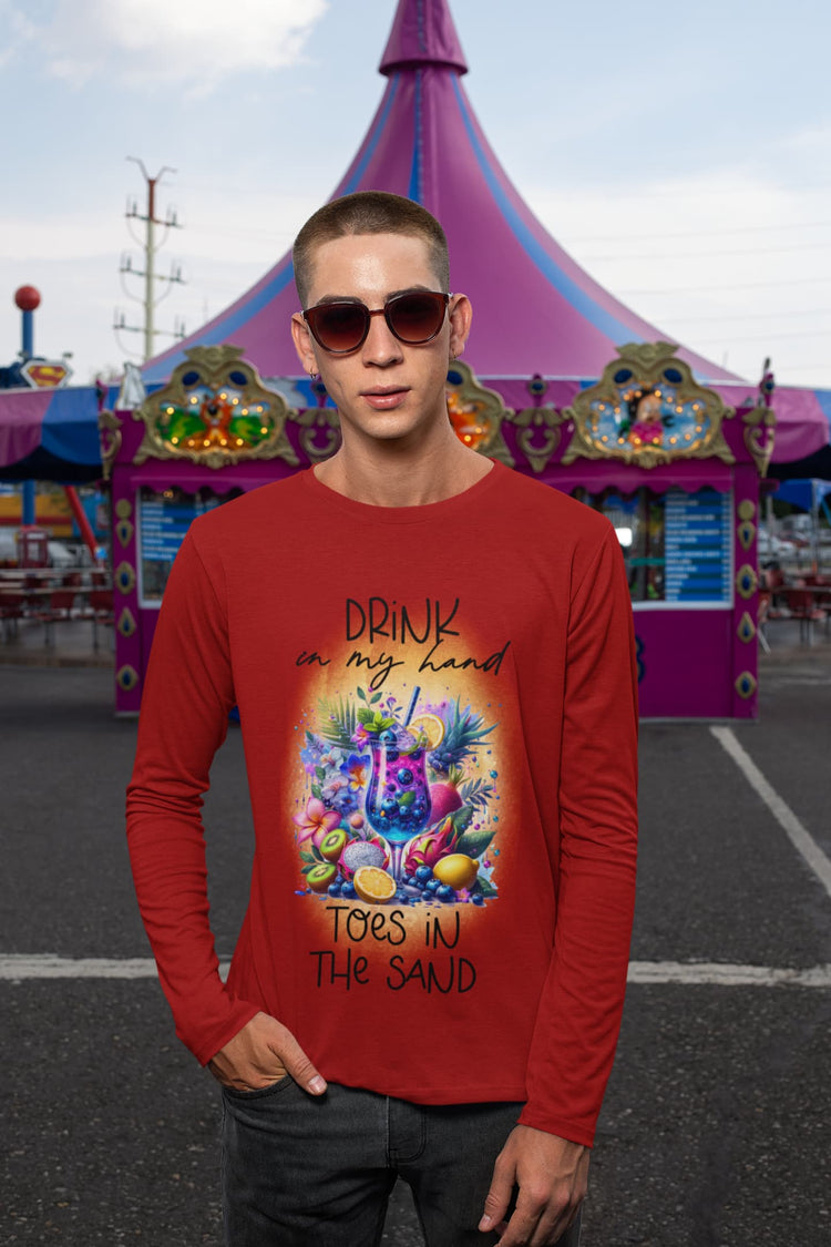 Person wearing a red long-sleeve shirt with a colorful graphic and text, standing in front of a festive tent.