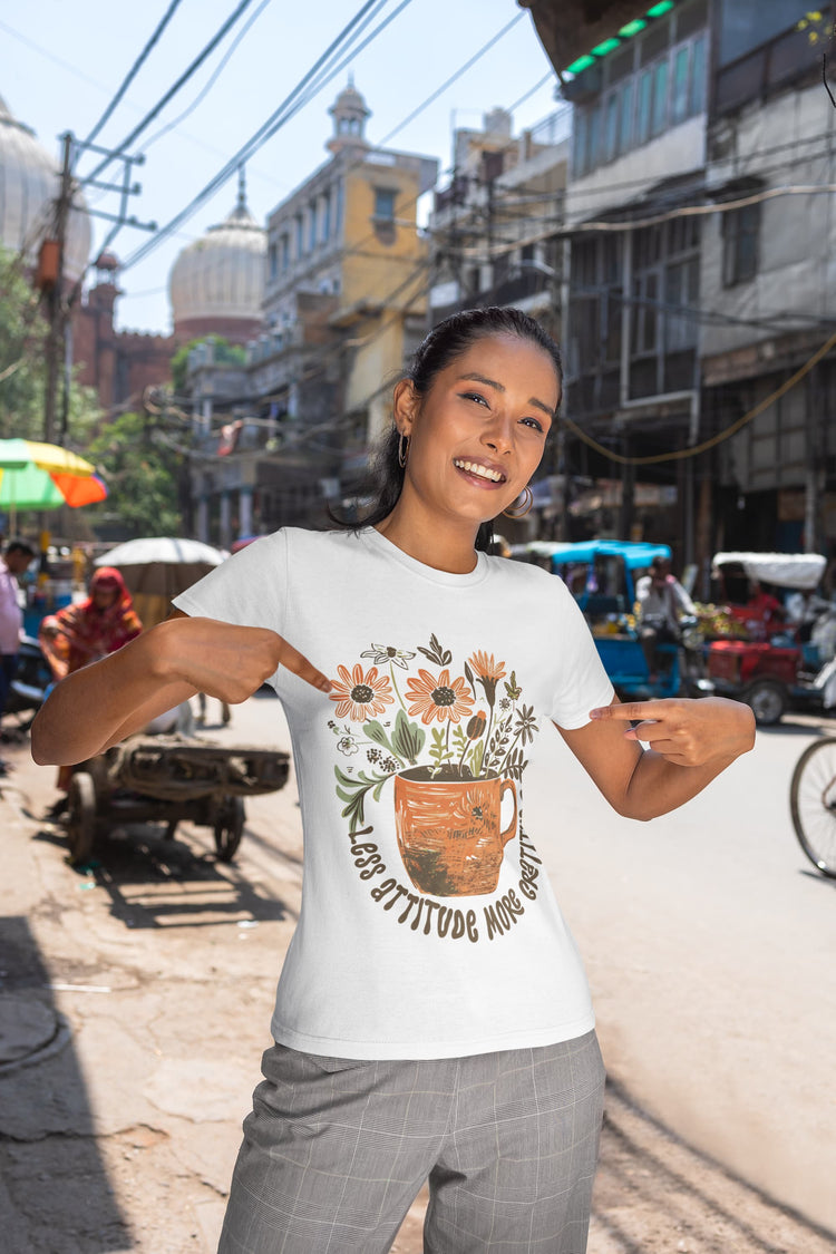 Woman wearing a t-shirt with a floral design on a busy street.