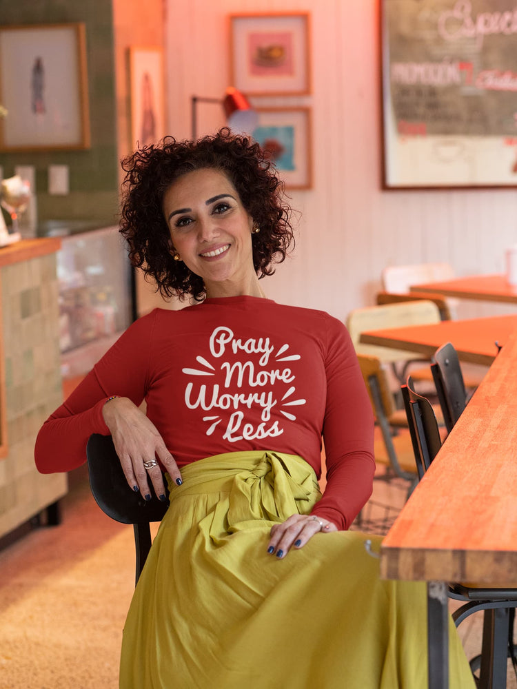 Woman in a red shirt with text sitting in a restaurant.