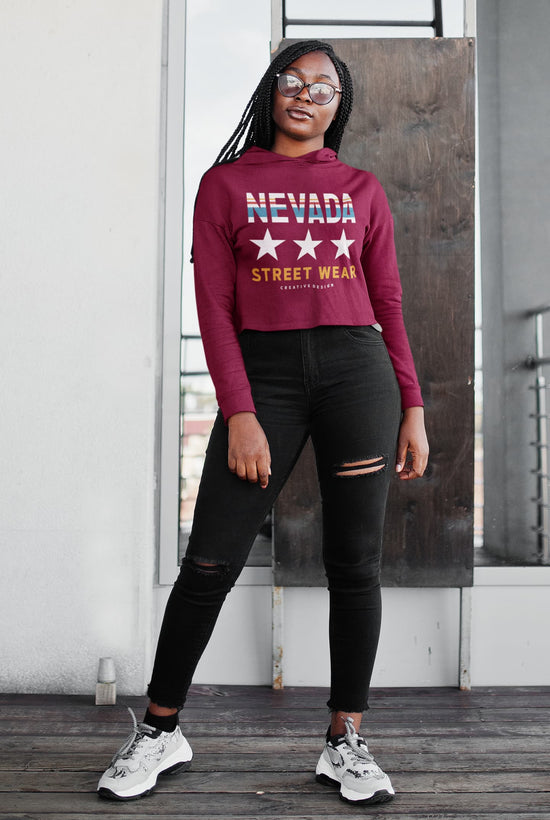 Person wearing a maroon sweatshirt with &