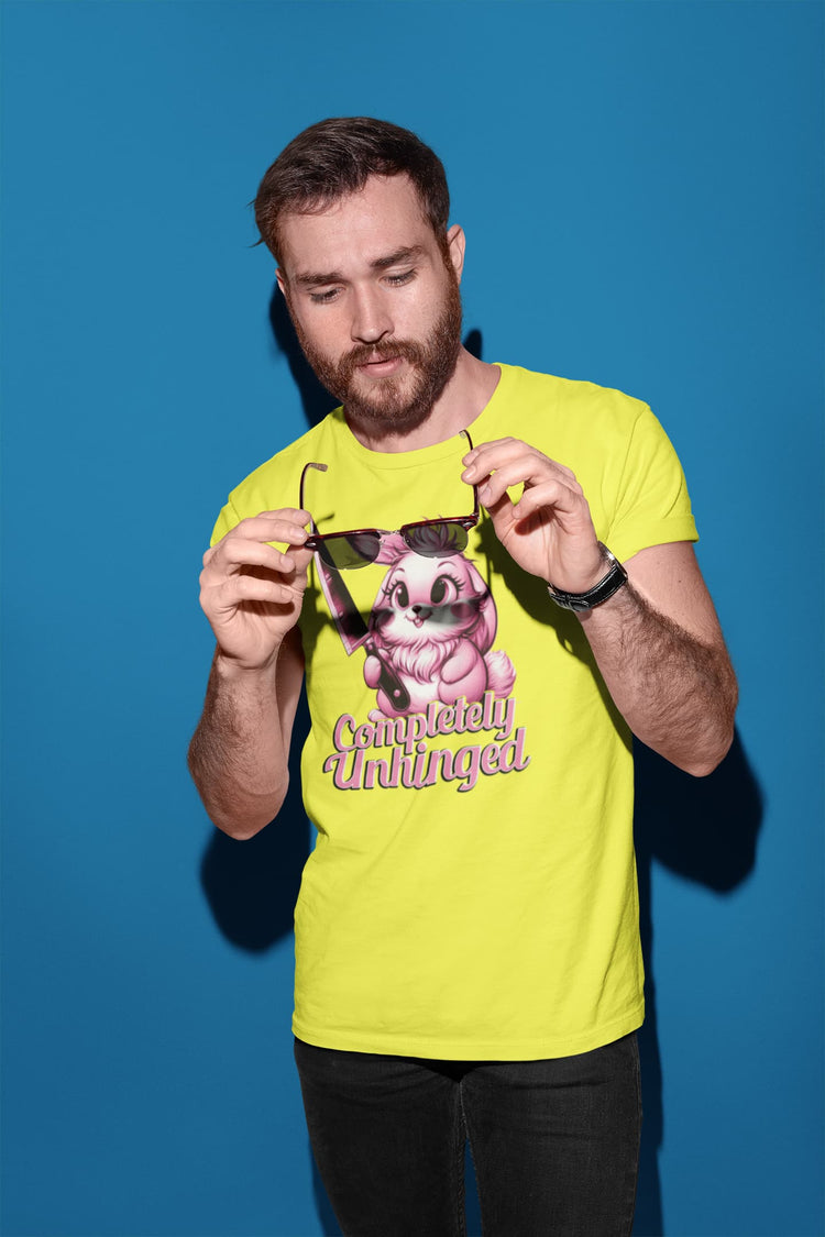 Man wearing a bright yellow t-shirt with a graphic design, holding sunglasses against a blue background