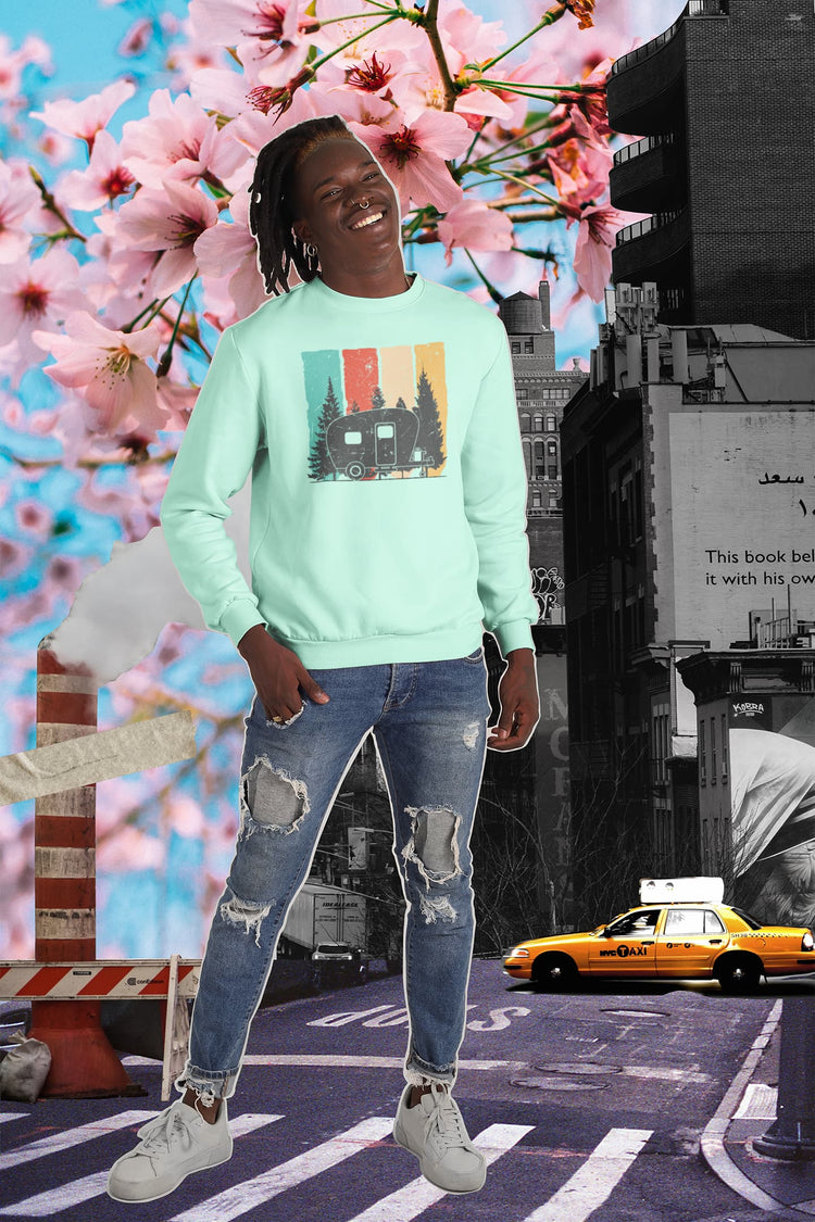 Person wearing a light green sweatshirt with a graphic design, standing in an urban setting with cherry blossoms.