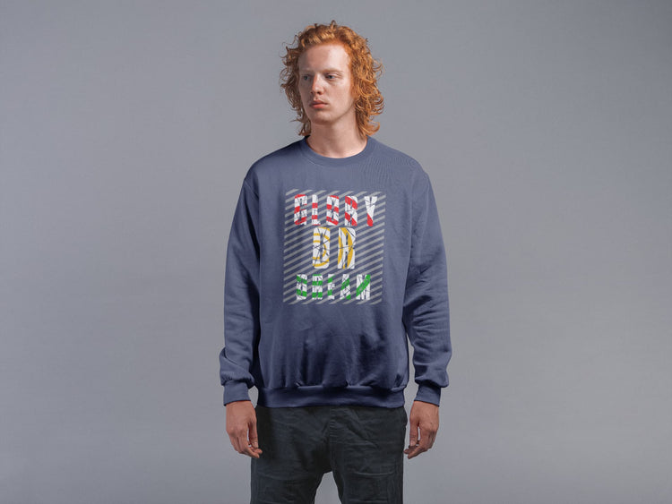 Person wearing a blue sweatshirt with colorful text design on a gray background