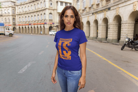 Woman wearing a blue t-shirt with text on a city street