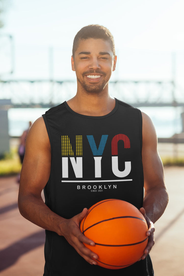 Man holding a basketball wearing an &