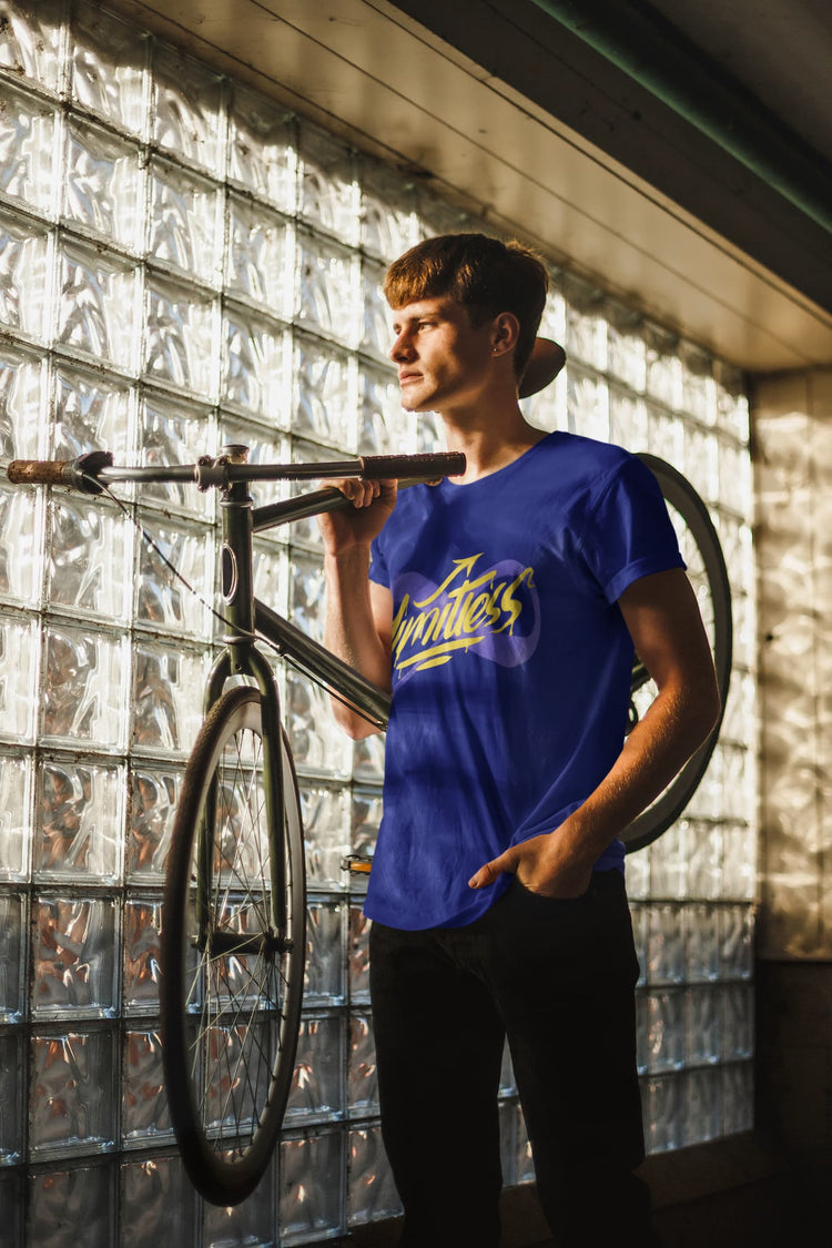 Person holding a bicycle against a glass block wall