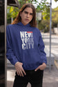 Person wearing a blue hoodie with &