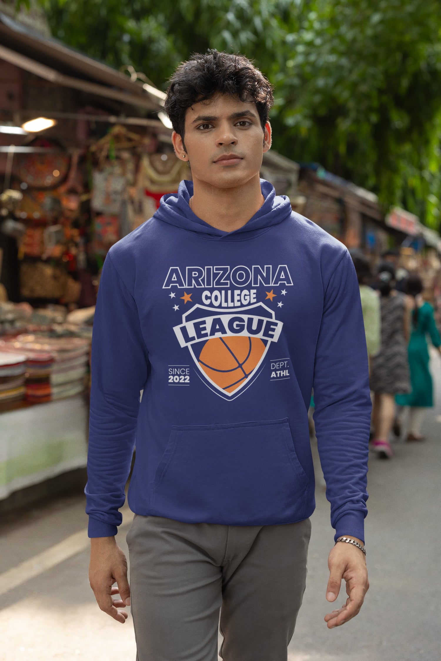 Man wearing a blue hoodie with &