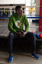 Person wearing a green hoodie with &
