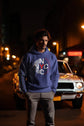 Man wearing a blue hoodie with &