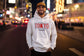 Man wearing a white hoodie with &