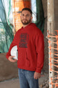 Man wearing a red hoodie with &