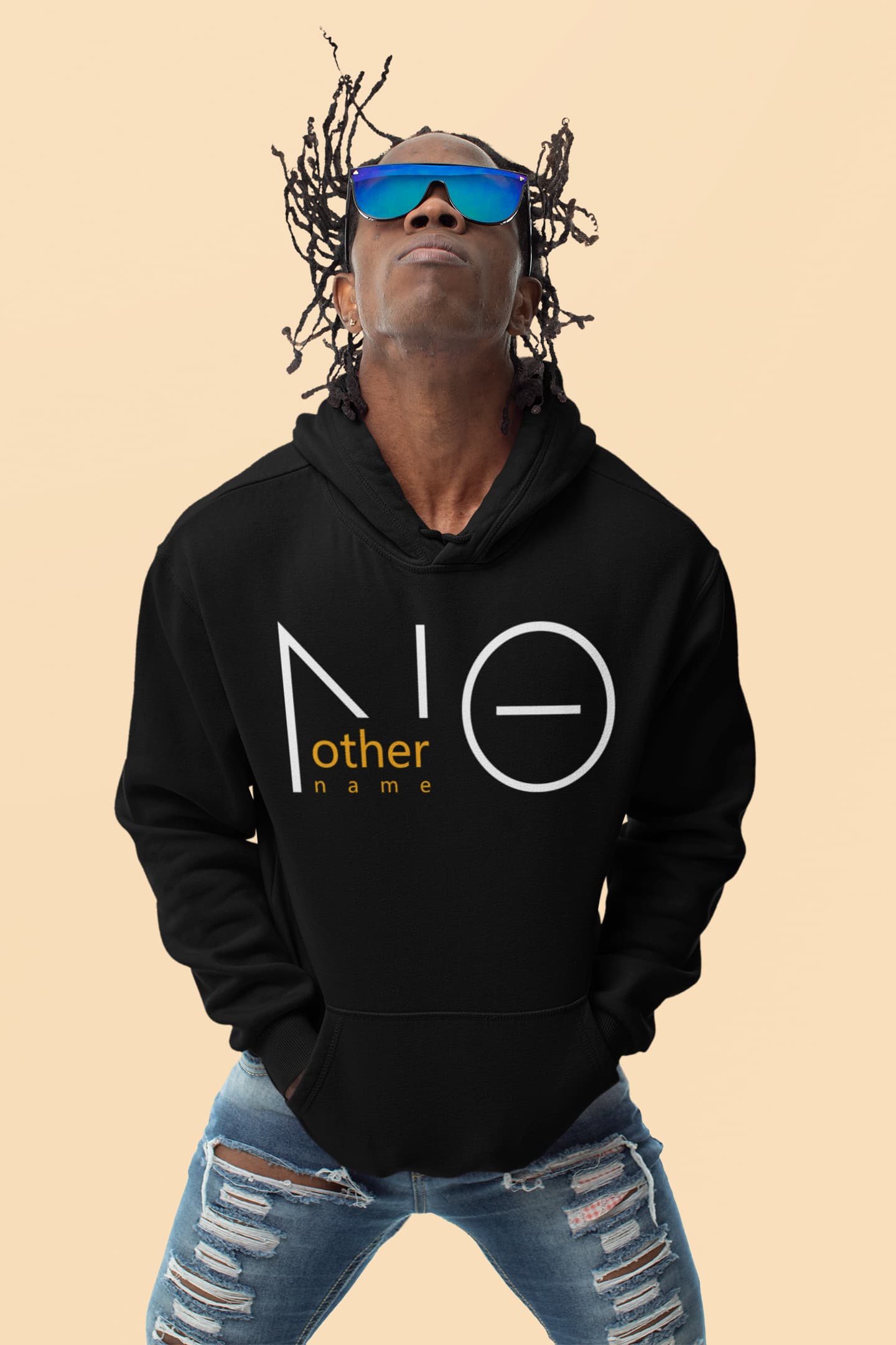 Person wearing a black hoodie with a logo and text, sunglasses, and ripped jeans on a beige background