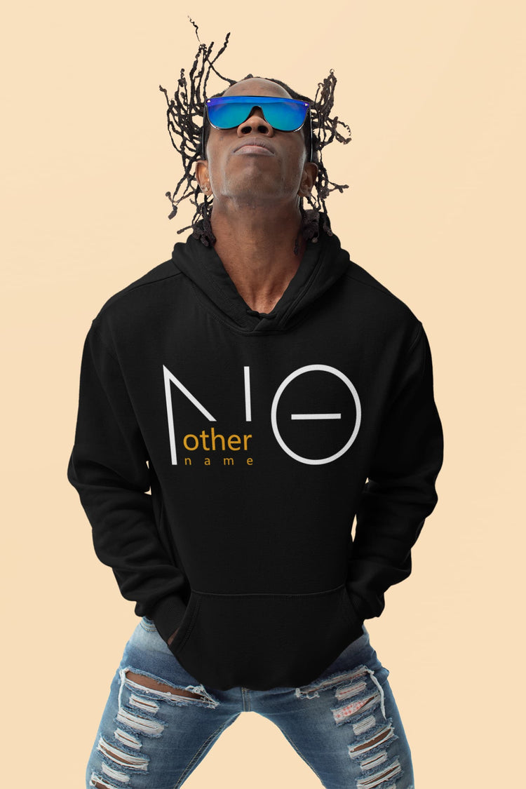 Person wearing a black hoodie with a logo and text, sunglasses, and ripped jeans on a beige background