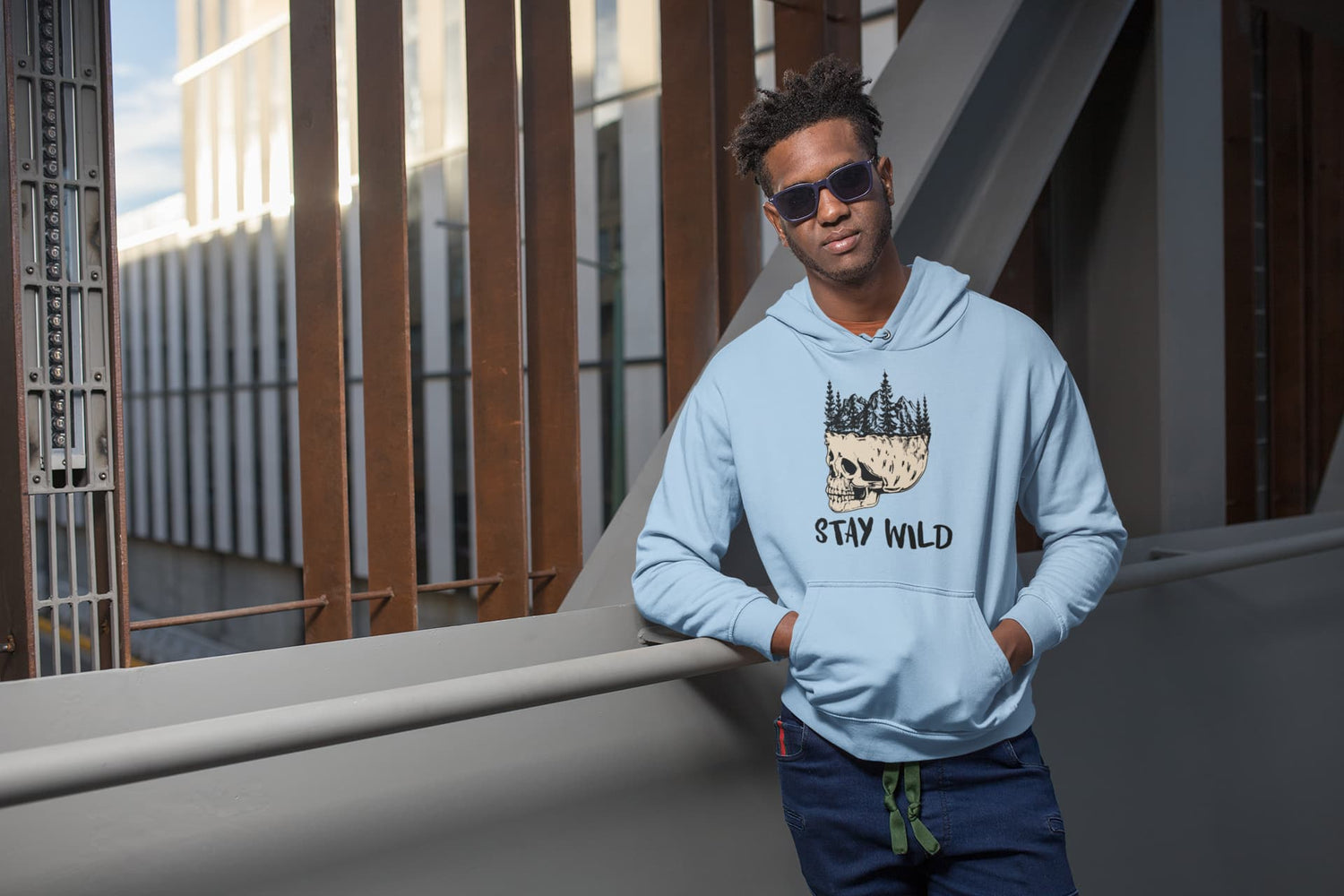 Man wearing a light blue hoodie with &