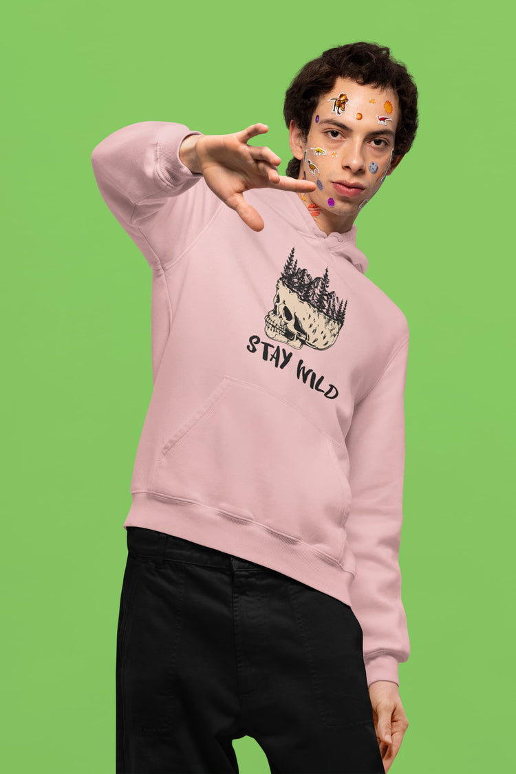 Person wearing a pink hoodie with a graphic design and text on a green background