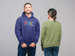 Two people wearing hoodies, one with a colorful &
