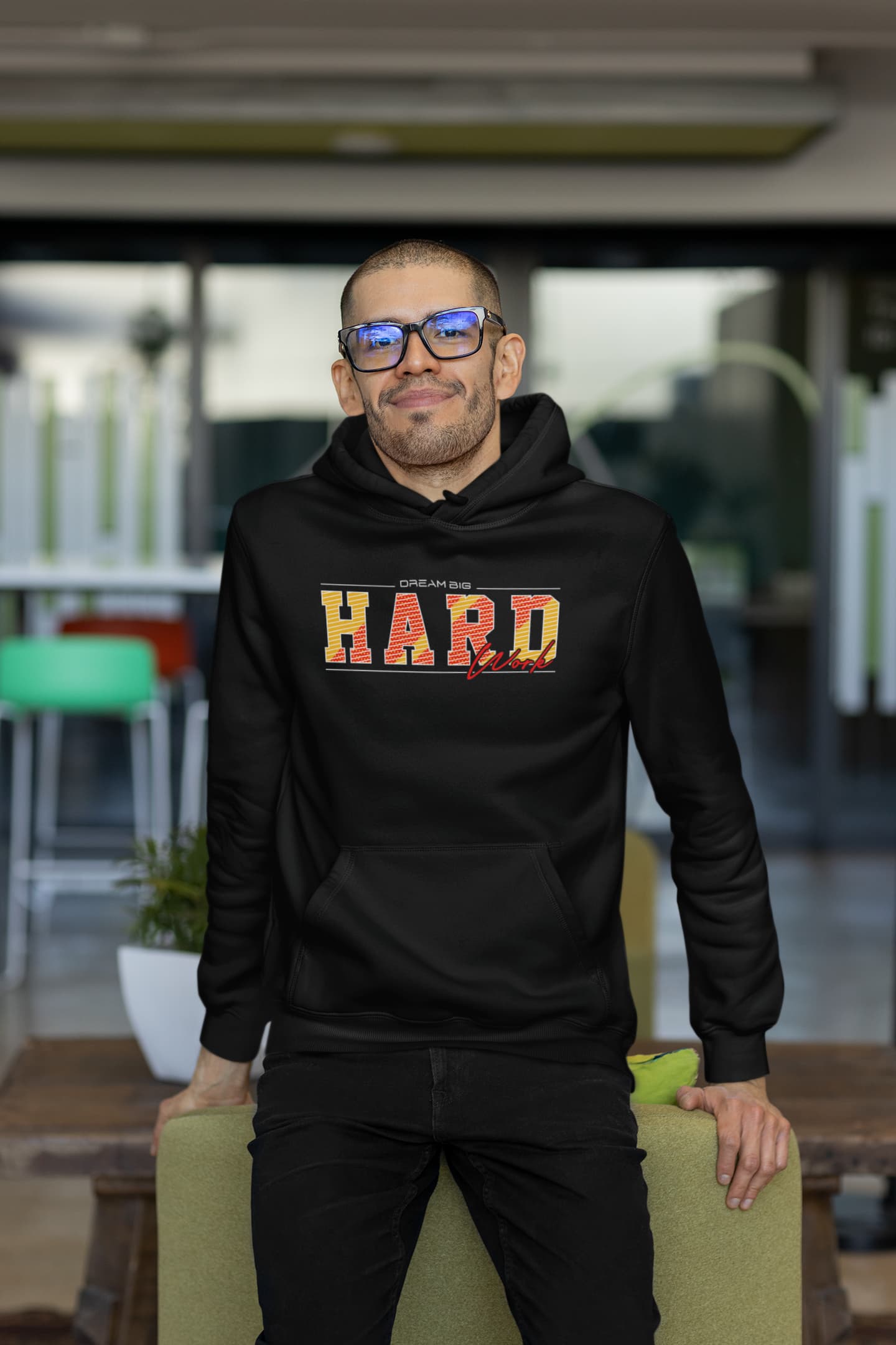 Man wearing a black hoodie with &