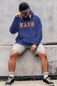 Person wearing a blue hoodie with &
