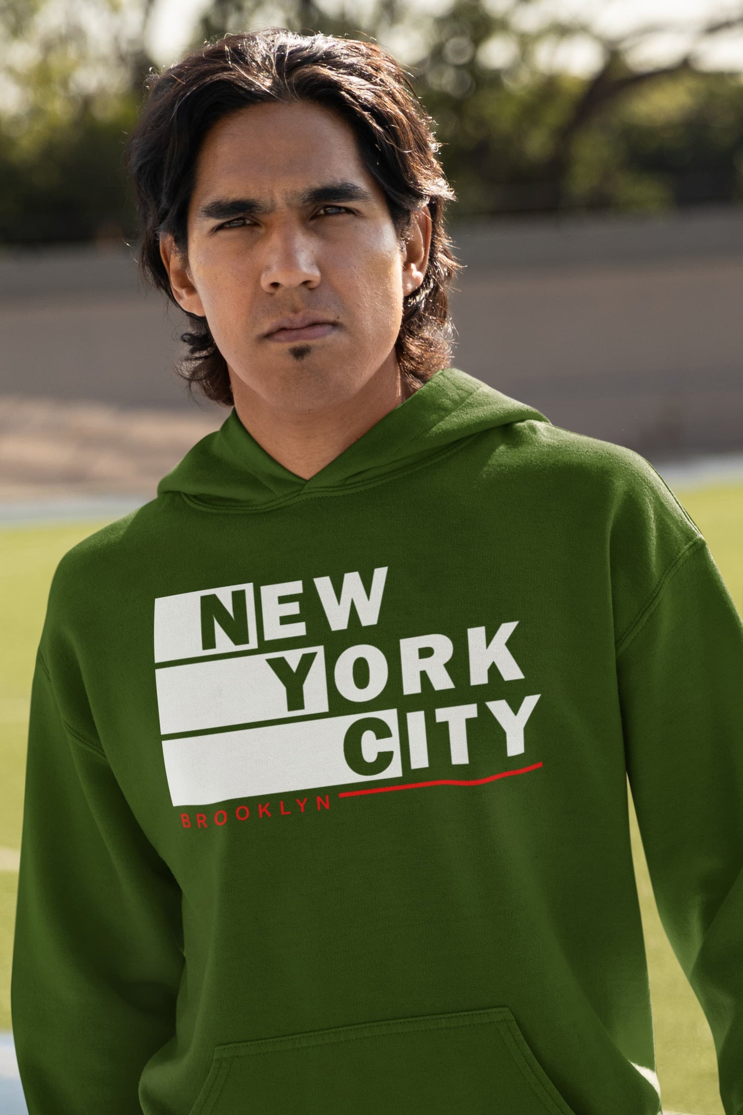 Person wearing a green hoodie with &