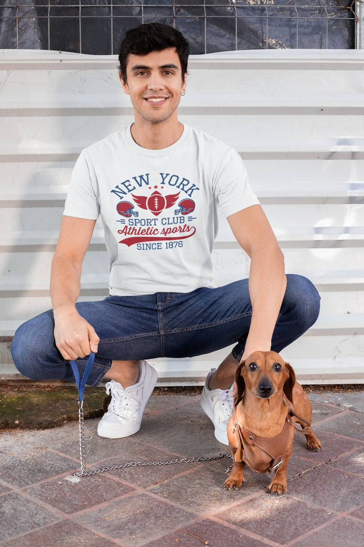 Man sitting on steps with a dachshund wearing a &