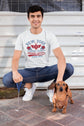 Man sitting on steps with a dachshund wearing a &